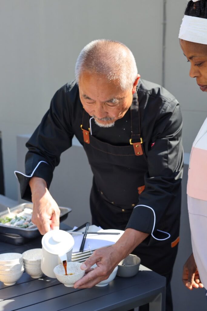 Chef Miya pouring sauce