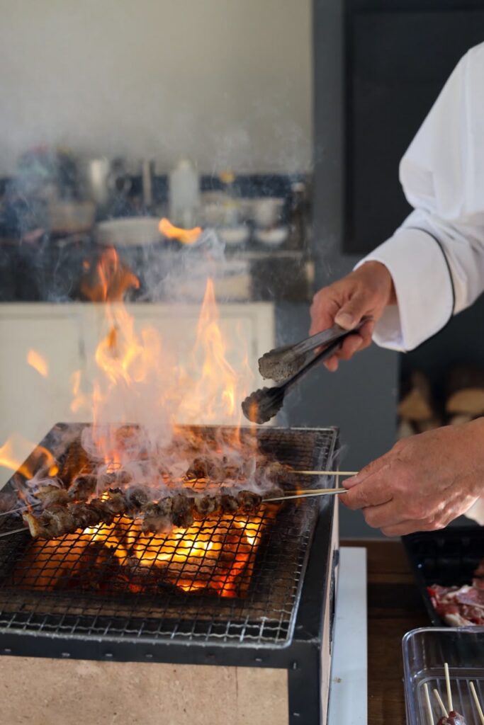 Close up of chef Miya cooking over flames at a hibachi grill